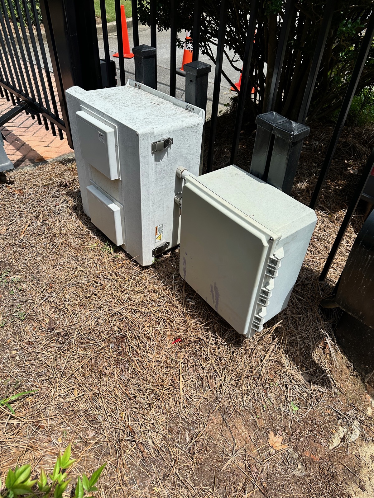 Weatherproof control enclosures at a community vehicle gate entrance
